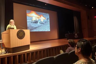 Zoe Weldon-Yochim presenting “Fighter Jets and Fallout: Attending to Militarized Western Shoshone Lands and Diverse Multi-Being Assemblages in Jack Malotte’s The End,” at the Smithsonian American Art Museum’s McEvoy Auditorium. Photo: Amelia Goerlitz.